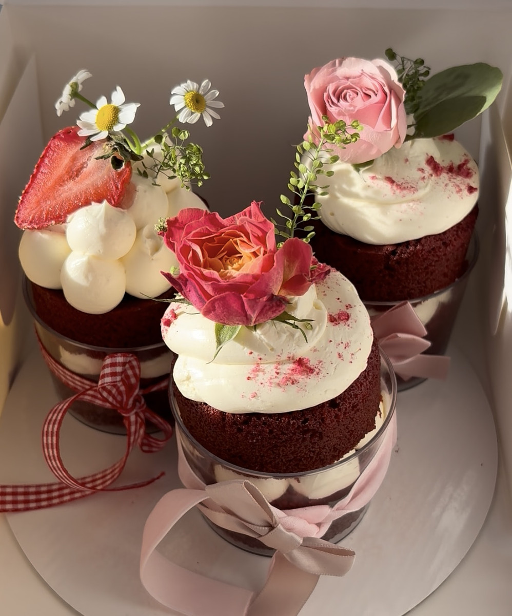 three mini cakes with bows and flowers