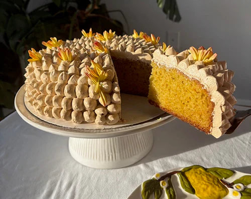 slicing an orange lemon cake