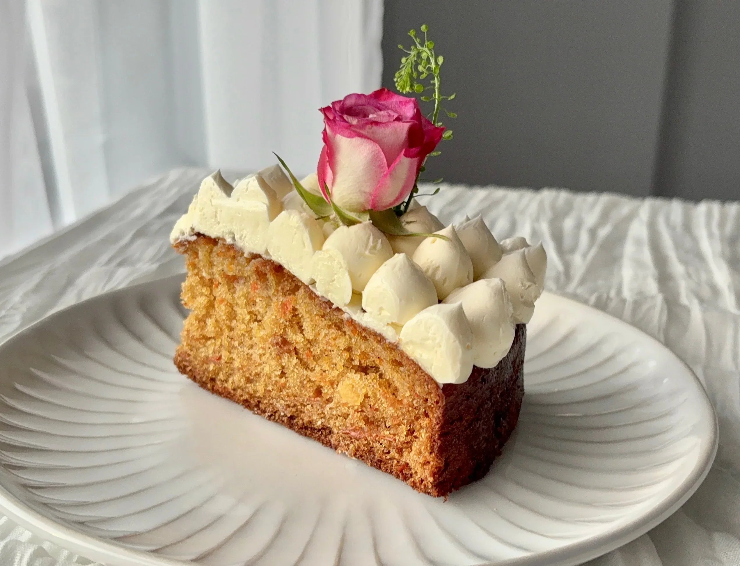 carrot cake slice with a rose on top