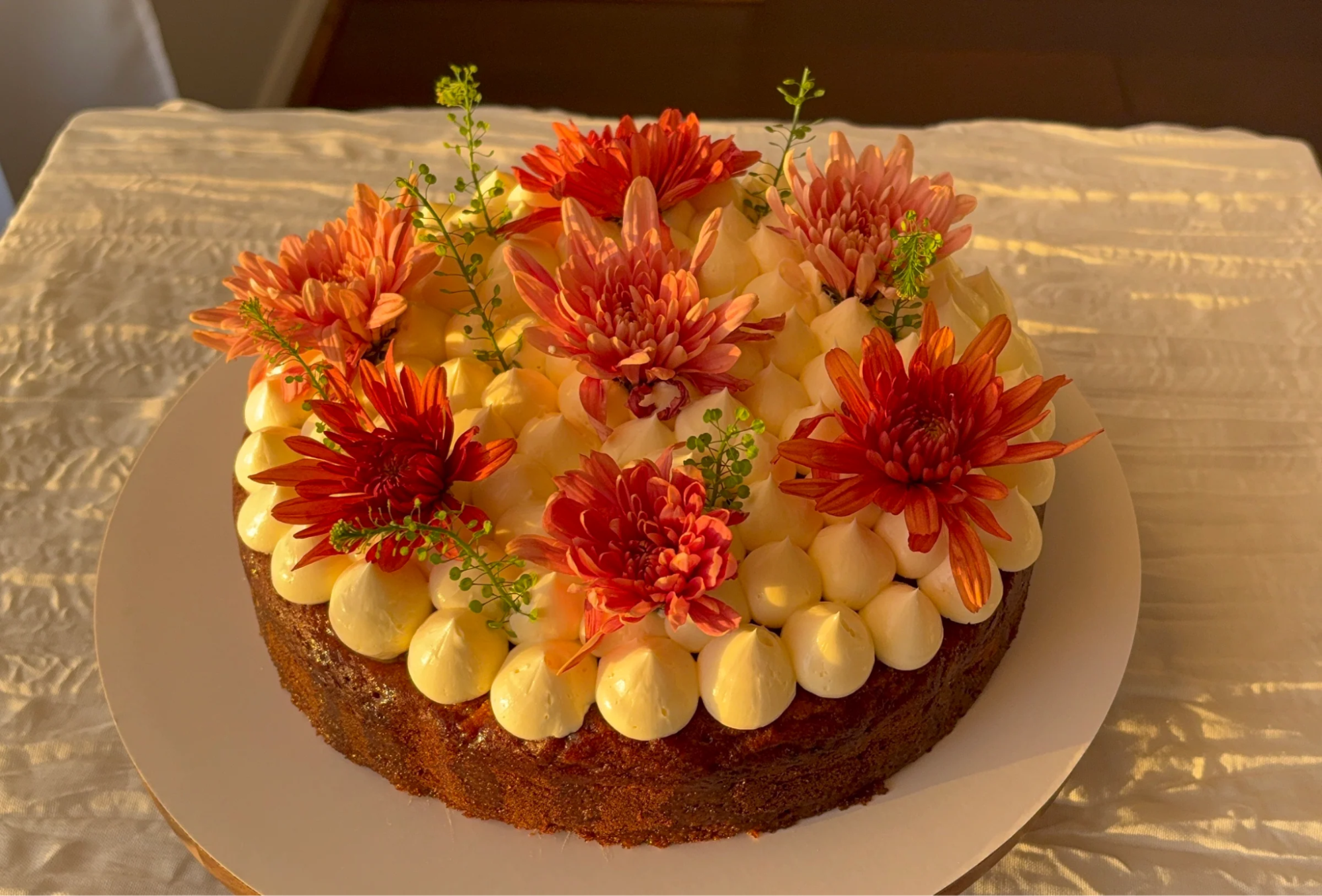 a cake with pink and orange flowers on top
