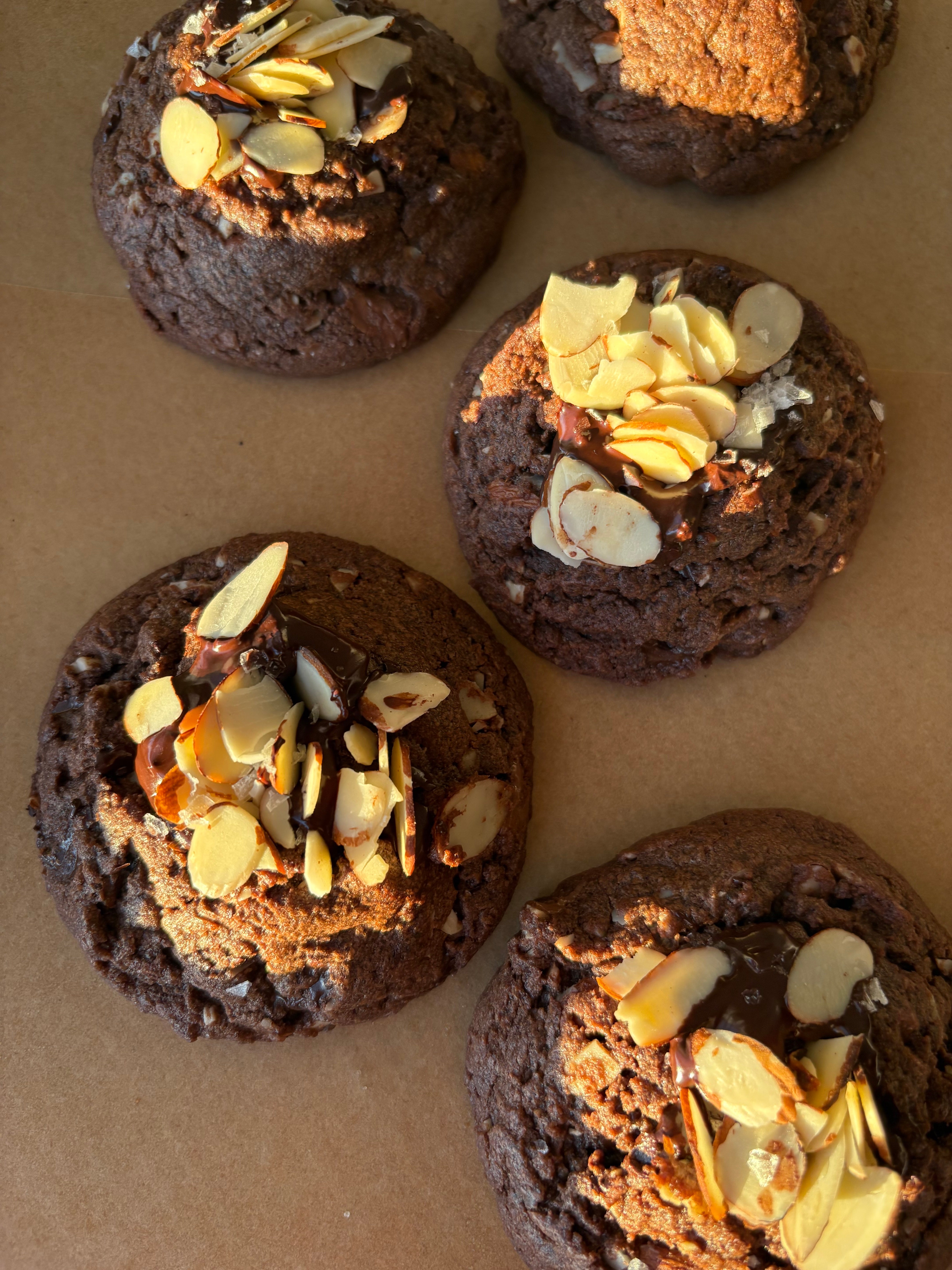 dark chocolate cookies topped with almonds