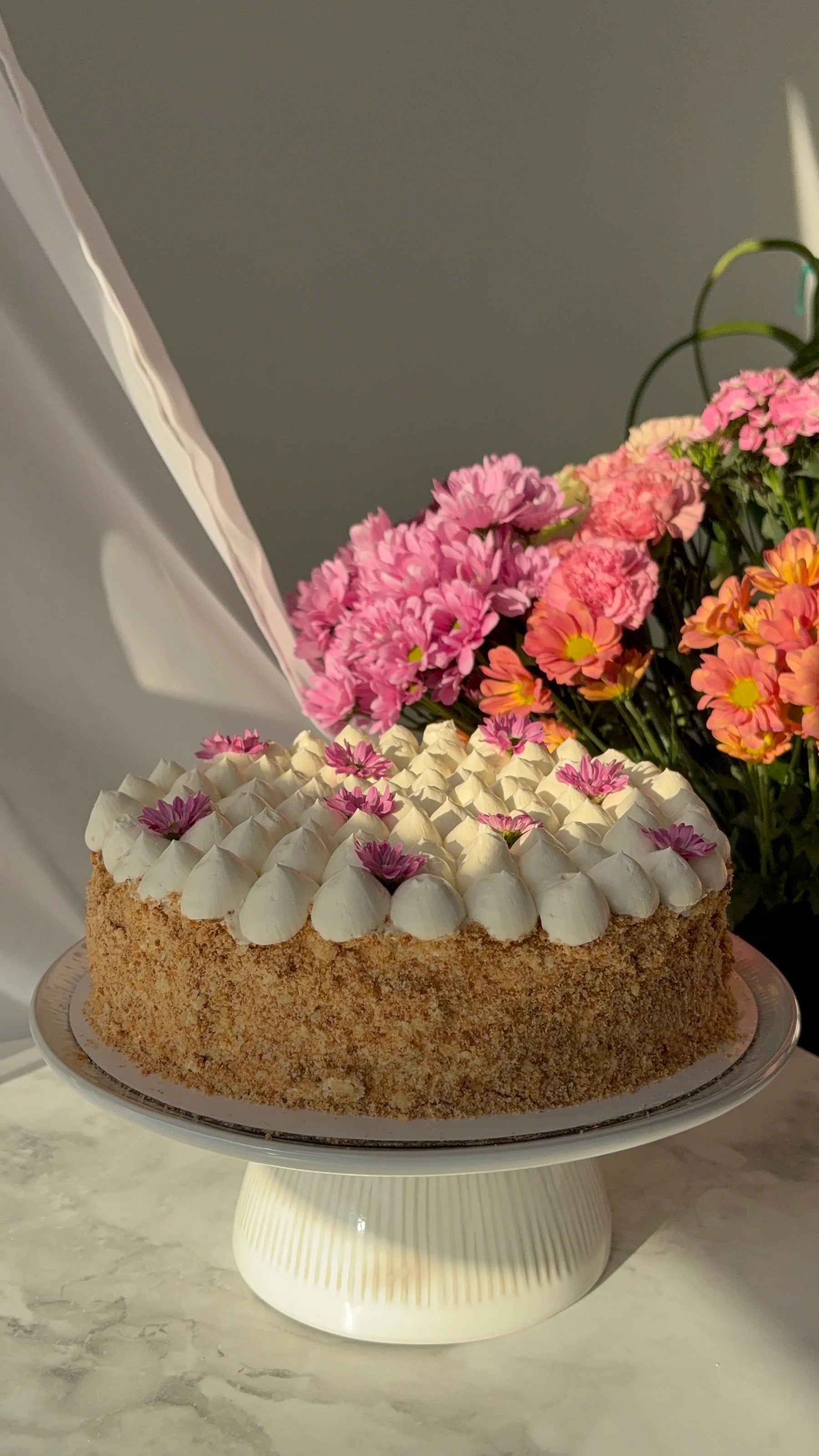 a napoleon cake with pink flowers on top