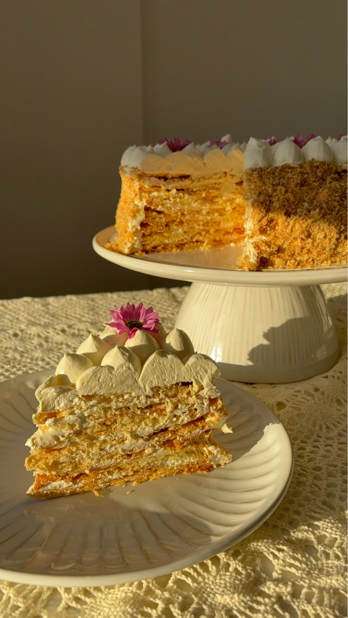 a napoleon cake slice with a pink flower on top