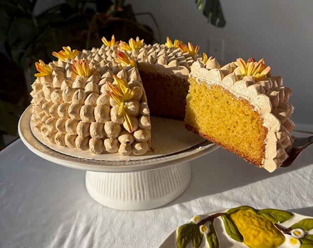 Orange Lemon Olive Oil Cake on a cake stand