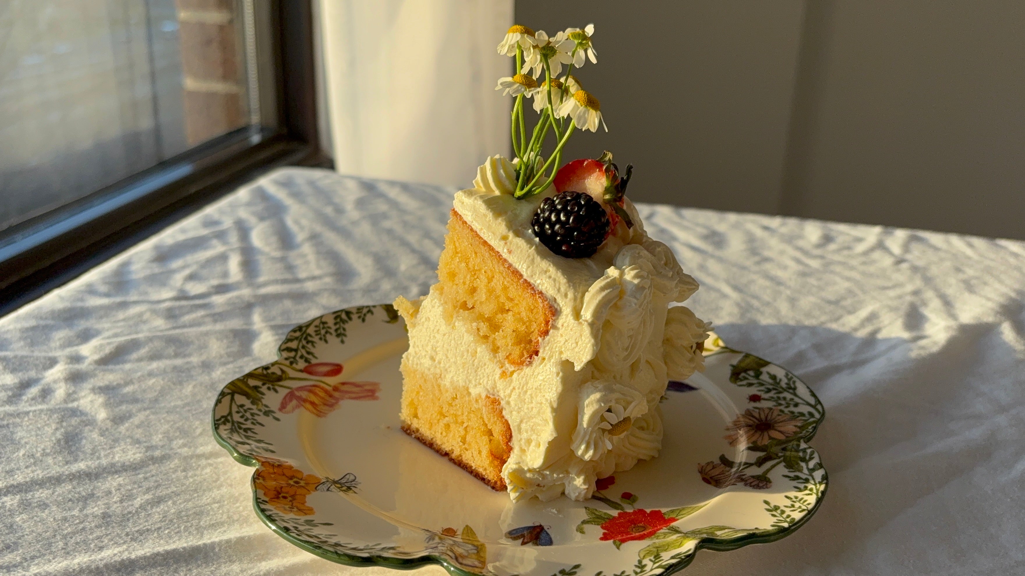 a slice of vanilla cake with Swiss meringue buttercream